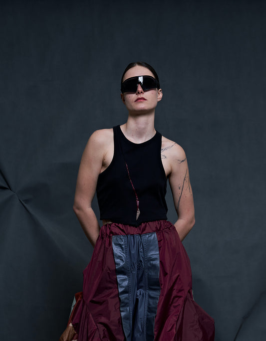 A UNIQUE BLACK UPCYCLED KNITTED CROPPED TANK with tent fabric detail