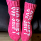 Pink hand-knitted socks by Grandmas and Grandpas with OUR SHIFT logo. 